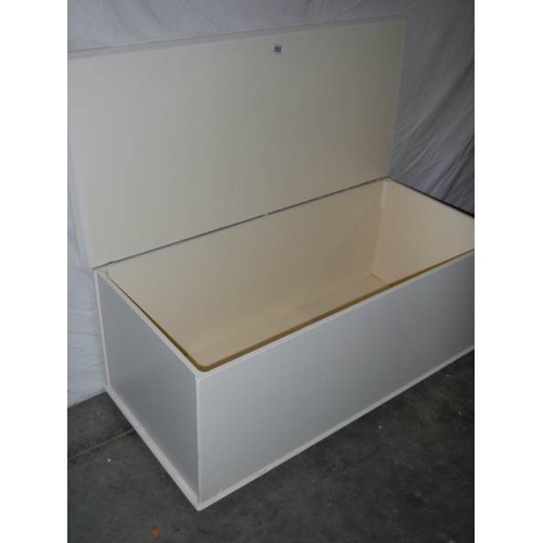 595 - A large painted blanket box on wheels.  108 x 50 x 48 cm.