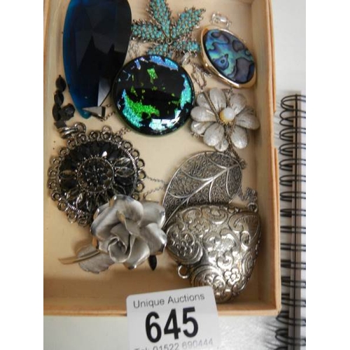 645 - A mixed lot of costume brooches etc.,