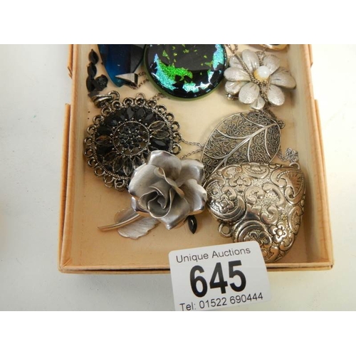 645 - A mixed lot of costume brooches etc.,