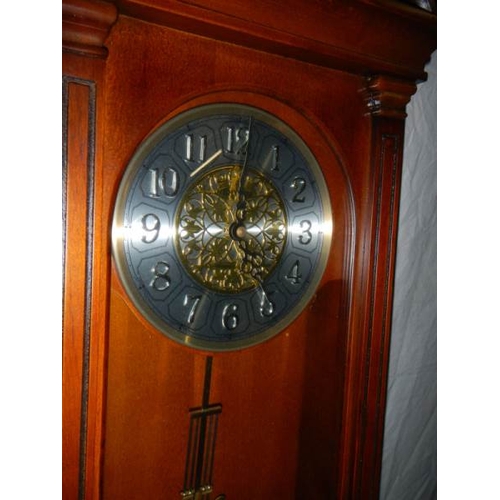 650 - A modern mahogany wall clock in good condition,.