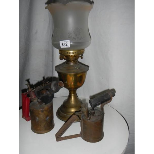 652 - An old brass oil lamp complete with chimney.