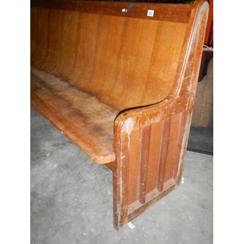 656 - A long old church pew, approximately 210 cm wide.