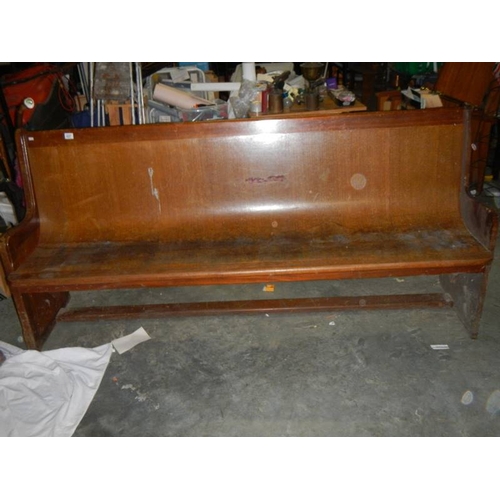 657 - A long old church pew, approximately 210 cm wide.