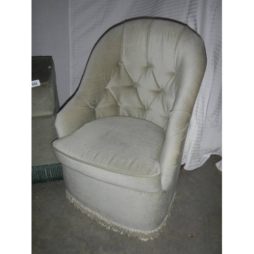 666 - A deep buttoned bedroom chair and a small ottoman.