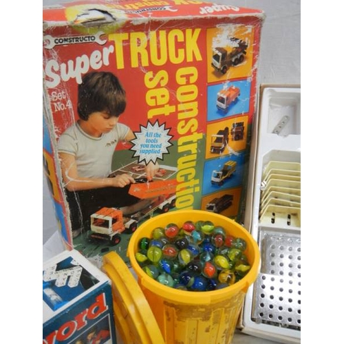 678 - A mixed lot of interesting items including truck construction set, large quantity of marbles etc.,