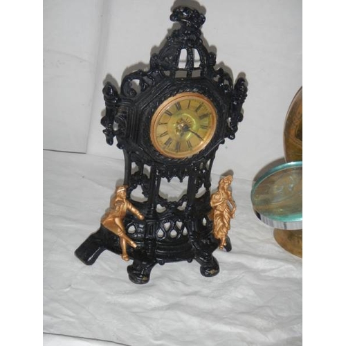 680 - A large brass vase, a bevelled mirror, a magnifying glass, a painted clock etc.,