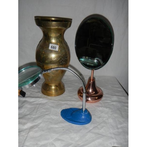 680 - A large brass vase, a bevelled mirror, a magnifying glass, a painted clock etc.,