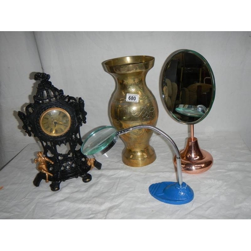 680 - A large brass vase, a bevelled mirror, a magnifying glass, a painted clock etc.,