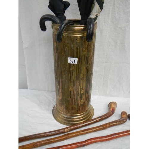 681 - A brass umbrella stand (47cm tall) with walking sticks and umbrella's.