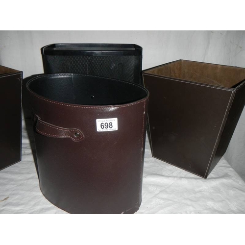 698 - 3 good hide covered waste paper bins and one other.