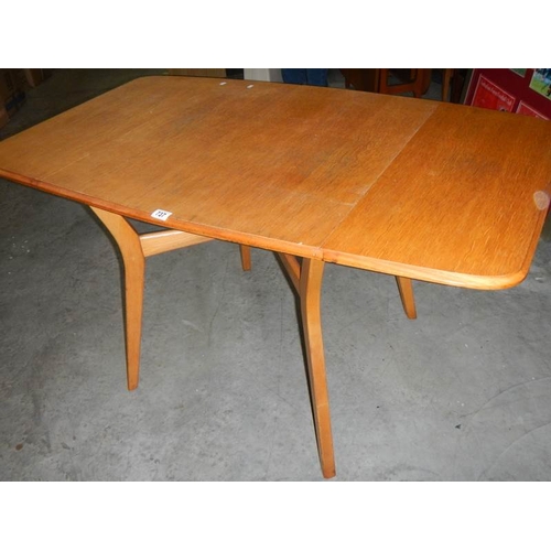 737 - An oak drop leaf dining table in the style of Ercol, 75 x 84 cm closed, 138 x 84 cm open.