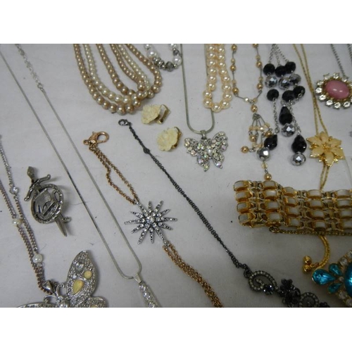 501 - A good mixed lot of costume jewellery including a glass clock, 25 items.