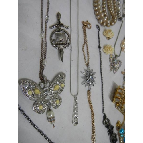 501 - A good mixed lot of costume jewellery including a glass clock, 25 items.