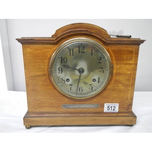 512 - A mahogany mantel clock with key (springs ok).