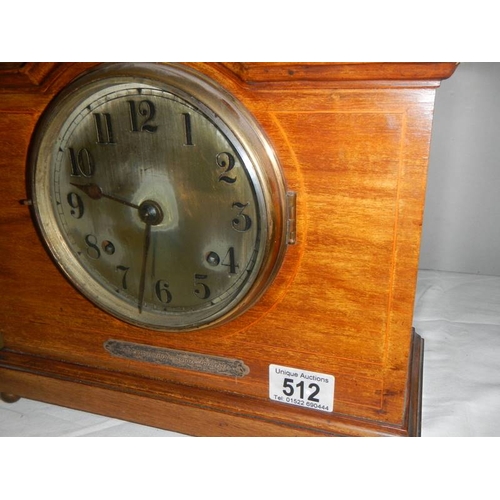 512 - A mahogany mantel clock with key (springs ok).