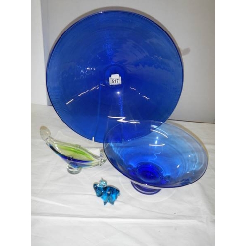 517 - A 40 cm diameter blue glass bowl and other blue glass ware.