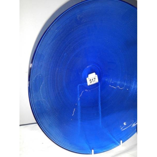 517 - A 40 cm diameter blue glass bowl and other blue glass ware.