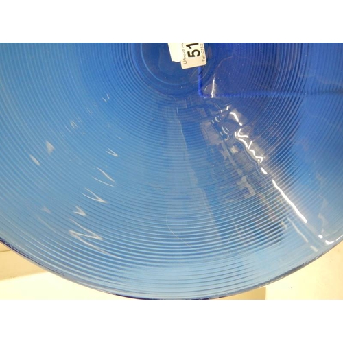 517 - A 40 cm diameter blue glass bowl and other blue glass ware.