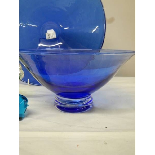 517 - A 40 cm diameter blue glass bowl and other blue glass ware.