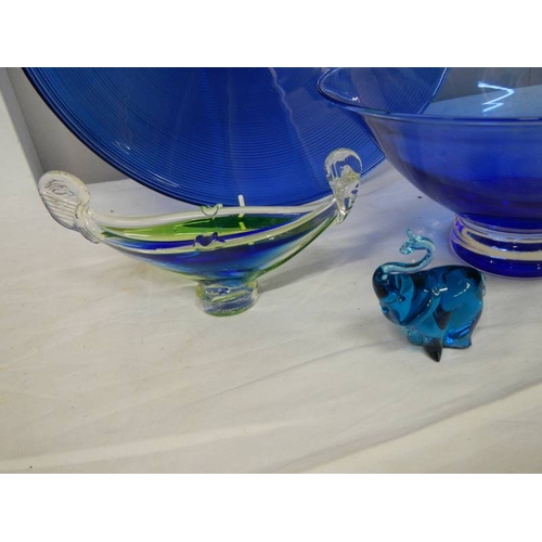 517 - A 40 cm diameter blue glass bowl and other blue glass ware.