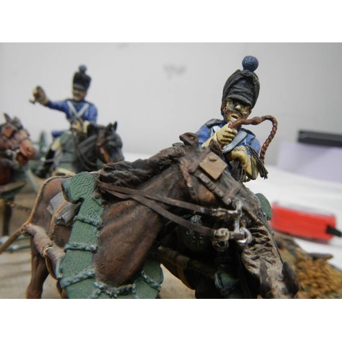 518 - A diorama featuring 4 horses pulling a cannon and soldiers on horseback.