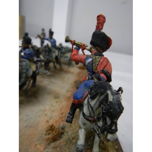 518 - A diorama featuring 4 horses pulling a cannon and soldiers on horseback.