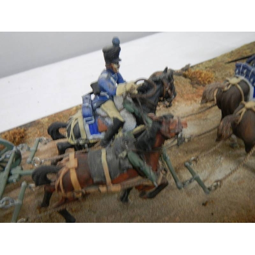 518 - A diorama featuring 4 horses pulling a cannon and soldiers on horseback.