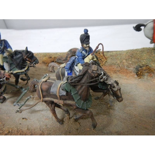 518 - A diorama featuring 4 horses pulling a cannon and soldiers on horseback.