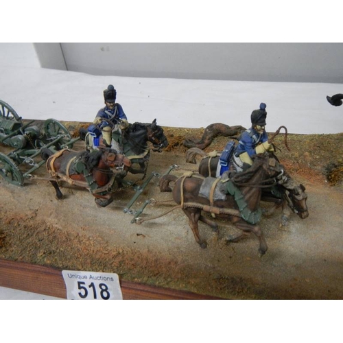 518 - A diorama featuring 4 horses pulling a cannon and soldiers on horseback.