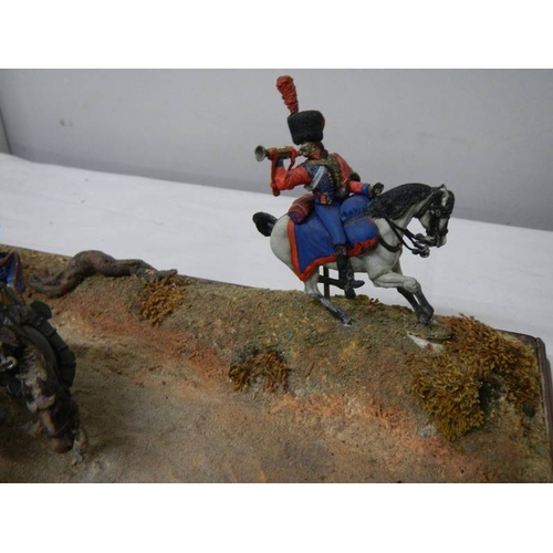 518 - A diorama featuring 4 horses pulling a cannon and soldiers on horseback.