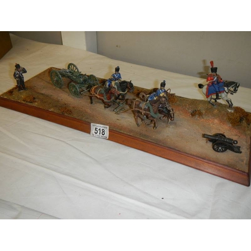 518 - A diorama featuring 4 horses pulling a cannon and soldiers on horseback.