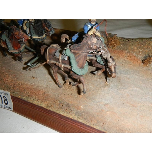 518 - A diorama featuring 4 horses pulling a cannon and soldiers on horseback.