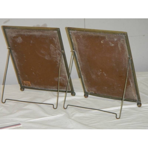 774 - A pair of early 20th century photo frames with easel stands made by Simple Simon Co., 34 cm x 26 cm.