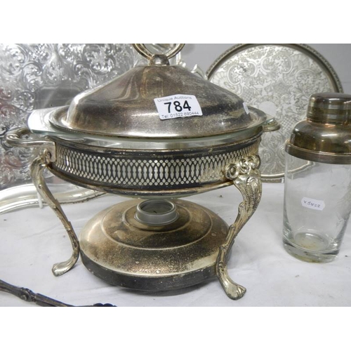 784 - A mixed lot of silver plate including heated serving dish, cocktail shaker, 2 trays etc.,