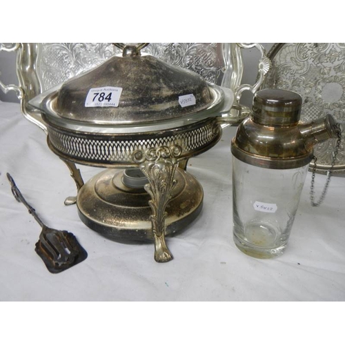 784 - A mixed lot of silver plate including heated serving dish, cocktail shaker, 2 trays etc.,