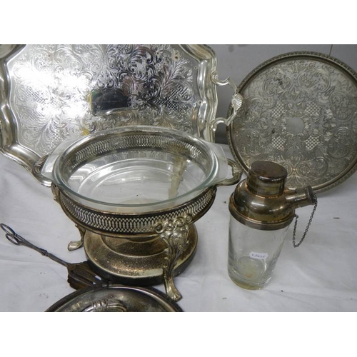 784 - A mixed lot of silver plate including heated serving dish, cocktail shaker, 2 trays etc.,