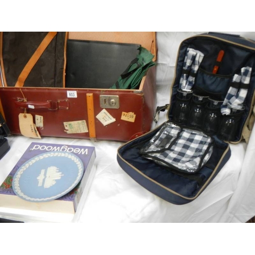 803 - A mixed lot including picnic set, cases, briefcase, Wedgwood plate etc.,