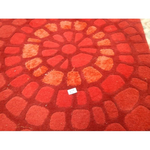 807 - A good quality rug in red, 183 x 122cm.