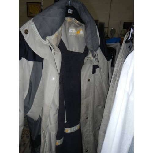 814 - 2 rails of vintage and other clothing including jackets, coats, football shirts etc.,