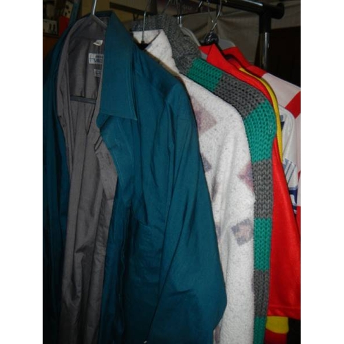 814 - 2 rails of vintage and other clothing including jackets, coats, football shirts etc.,