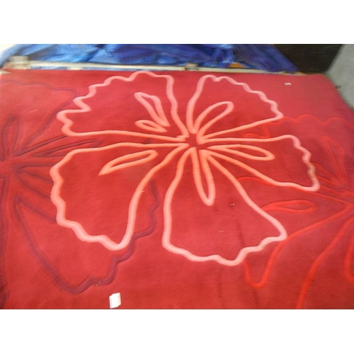 815 - A red patterned rug, 240 x 140 cm, in good condition.