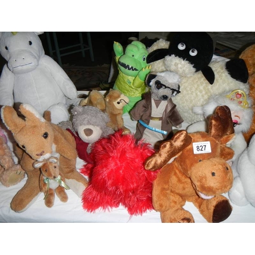 827 - A large quantity of soft toys including Bugs Bunny, MIckey Mouse etc., In excess of 30 in total.