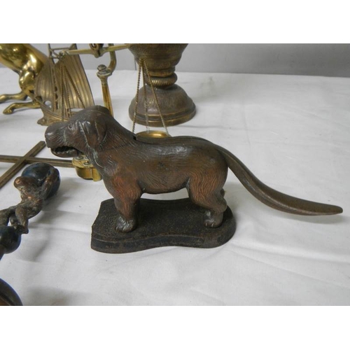 569 - A mixed lot of brassware including dog nut cracker, rearing horse, dog, balance scales etc.,