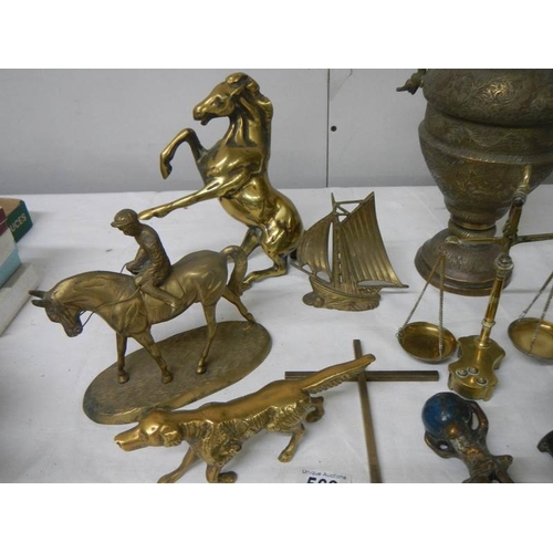 569 - A mixed lot of brassware including dog nut cracker, rearing horse, dog, balance scales etc.,