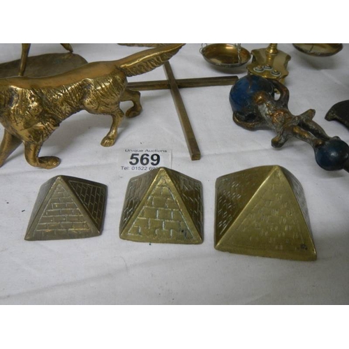 569 - A mixed lot of brassware including dog nut cracker, rearing horse, dog, balance scales etc.,