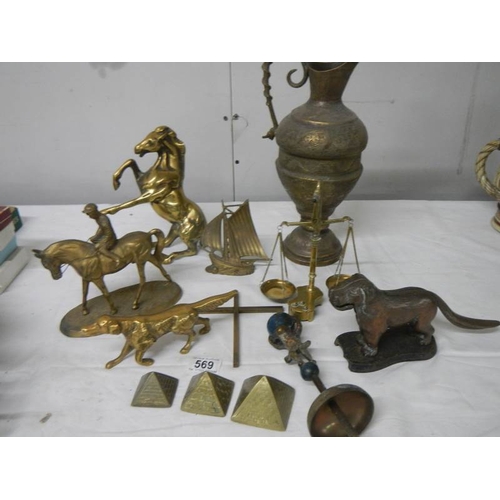 569 - A mixed lot of brassware including dog nut cracker, rearing horse, dog, balance scales etc.,