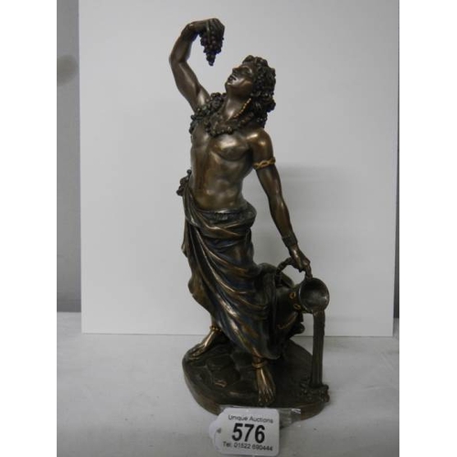 576 - A bronzed figure of a male leaning against a large water urn in excellent condition, 27 cm tall.