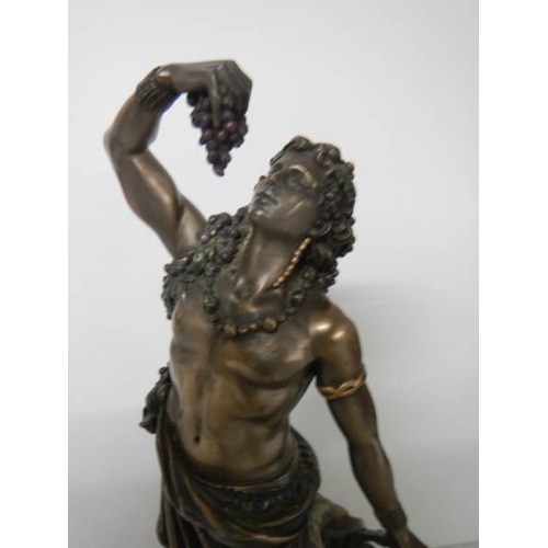 576 - A bronzed figure of a male leaning against a large water urn in excellent condition, 27 cm tall.