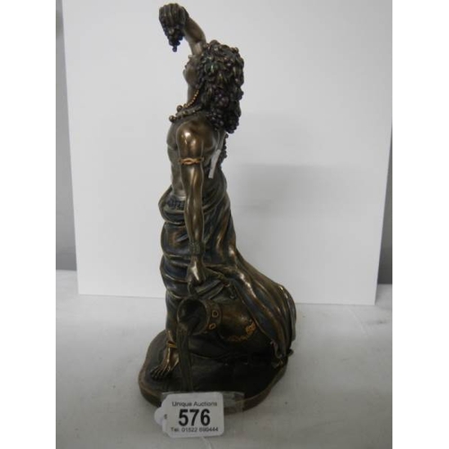 576 - A bronzed figure of a male leaning against a large water urn in excellent condition, 27 cm tall.