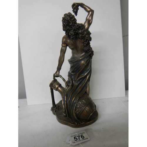 576 - A bronzed figure of a male leaning against a large water urn in excellent condition, 27 cm tall.